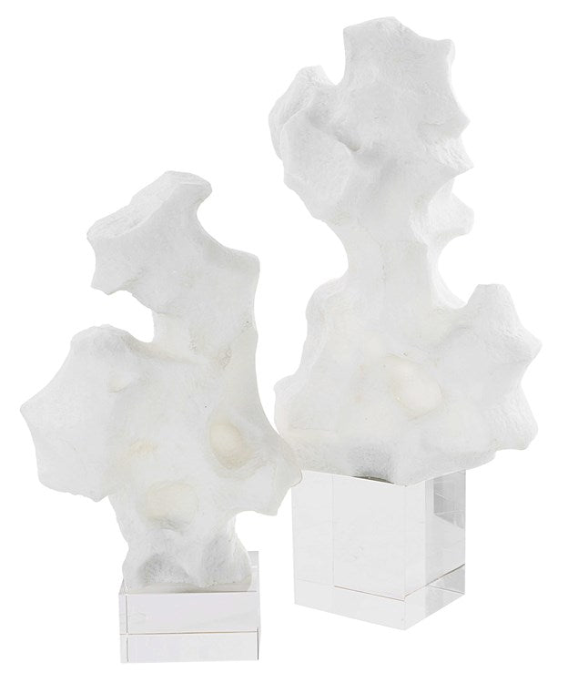 Two floating white abstract sculptures.