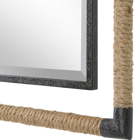 Decorative mirror with a horse sculpture and vase on a console table against a white wall.