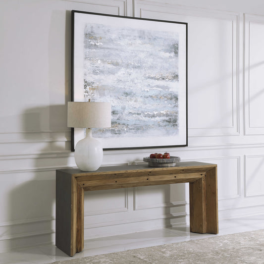 Rustic wood console on white living room wall with white decorative lamp and tray.