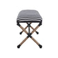 Side view of a nautical bench with iron frame and rope covered legs for accent.