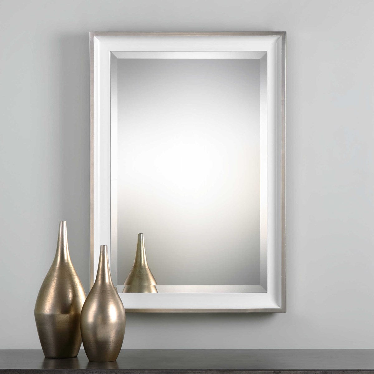 A glossy silver rectangular mirror with a silver leaf outer edge, displayed vertically.