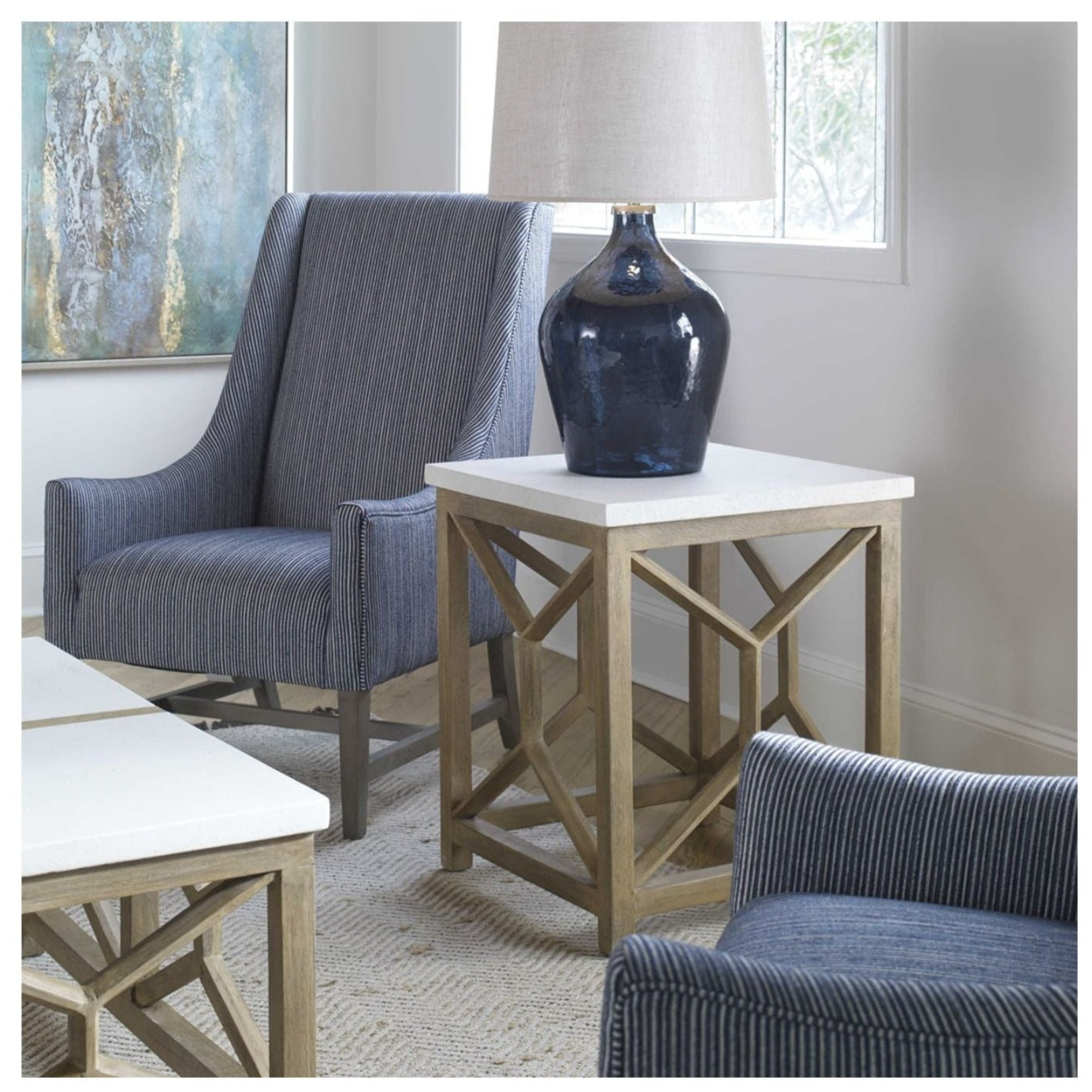 Square accent table with limestone top and reclaimed wood base. Shown in room setting with occasional chairs and lamp.